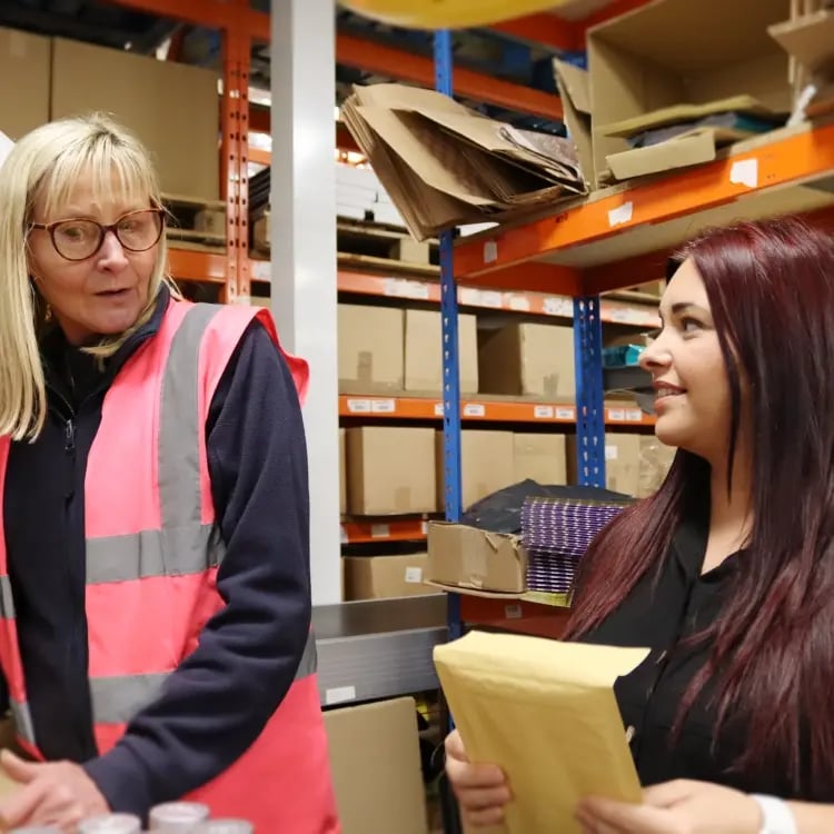 Image of Emma nicholson chatting in warehouse