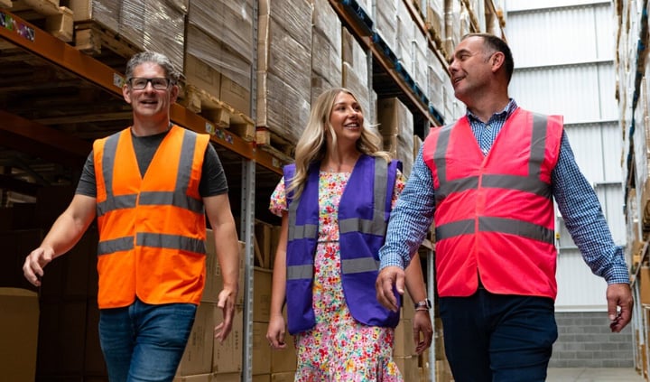 people walking through a warehouse