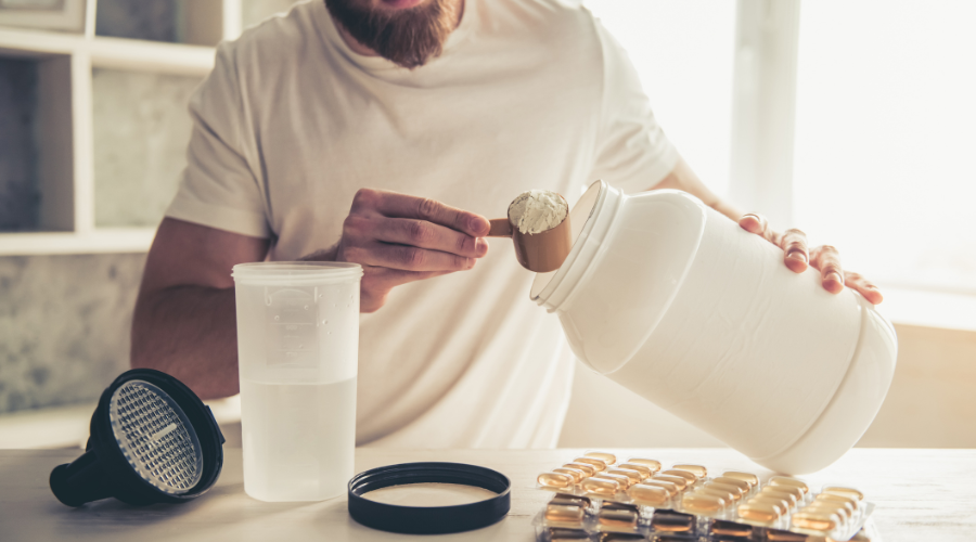 Man preparing protein supplement drink at home
