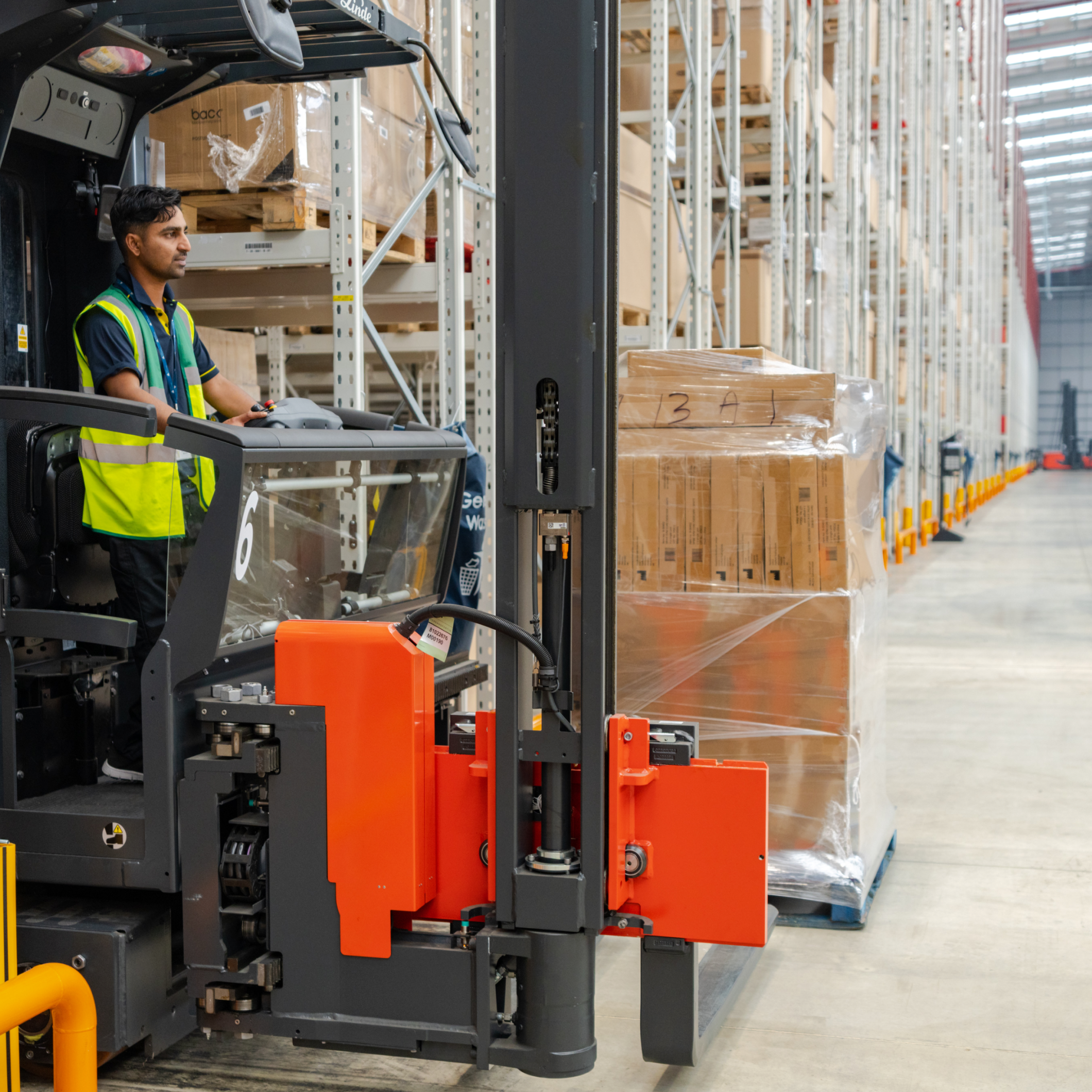Man on forklift truck in warehouse
